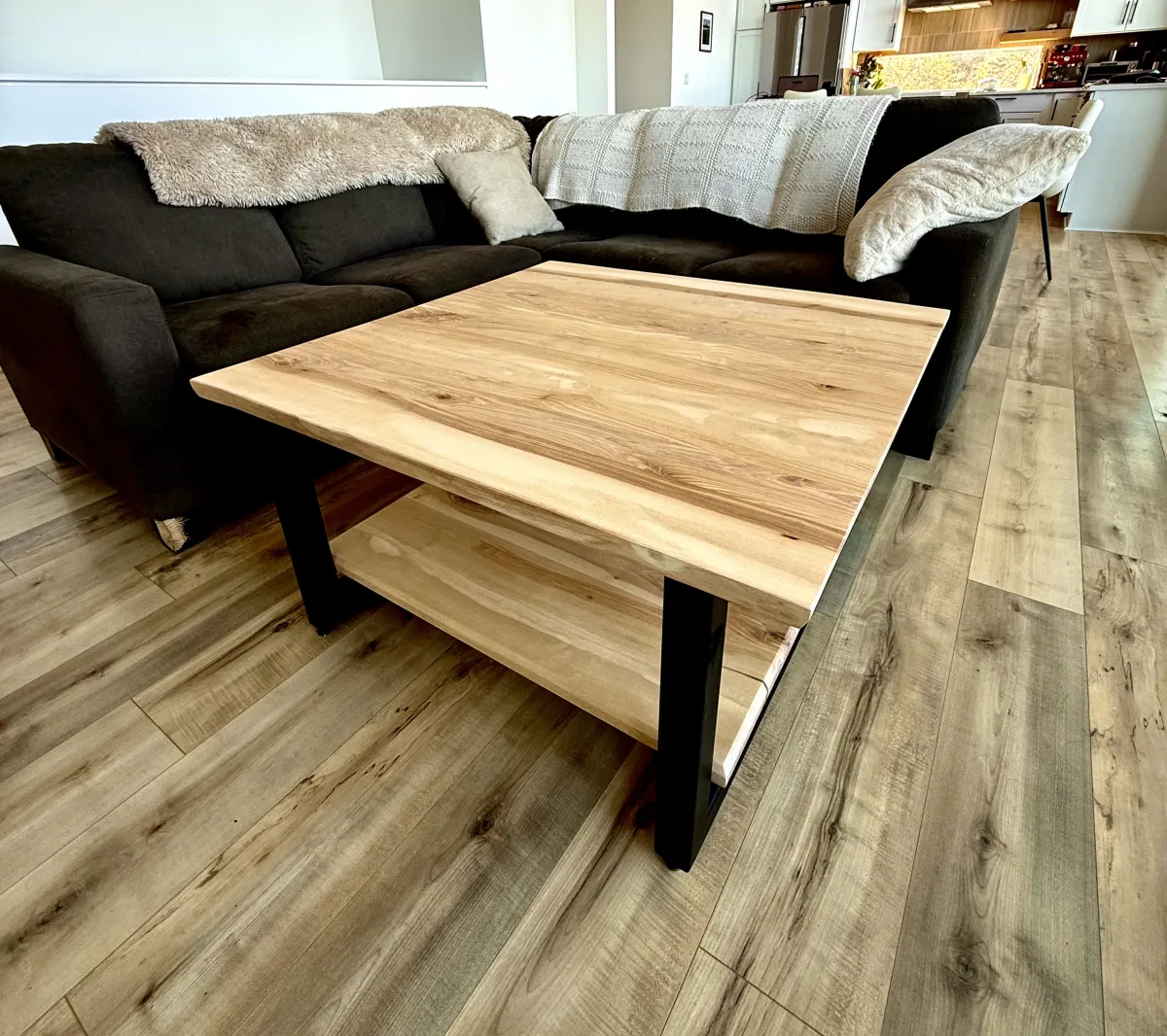 Maple coffee table with live edge and black steel legs in living room